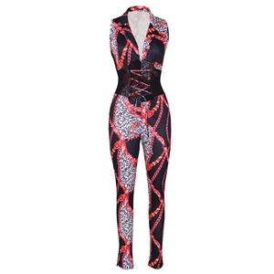 Detail of waist mesh splice and lace-up drawstring on chain print jumpsuit
