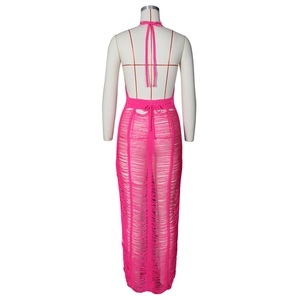 Close-up of fuchsia knit dress with tiered fringe detail and backless halter neck design