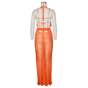 Detail of orange hollow out knit backless top and tassel beach skirt set for women