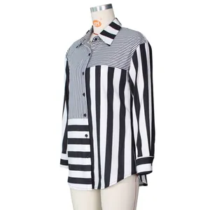 Detail of loose shirt dress featuring contrasting black and white mixed striped patterns