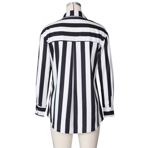 Detail view of back of a black and white striped shirt with central pleat and cuffed sleeves