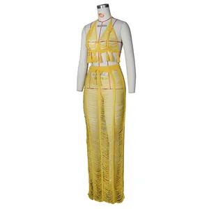 Detail of yellow knit crochet beach set featuring fringe trim and hollow out texture