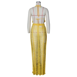 Detail of yellow crochet knit beach set showing fringed hem and hollow out texture
