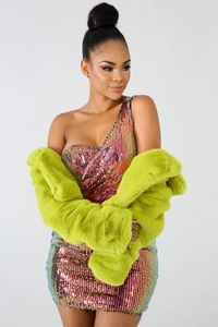 Detailed view of women's bright green faux fur jacket paired with a sequin party dress