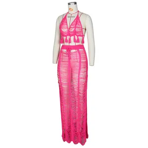 Detail of rose red crochet two-piece beach set with tassel hem and knit hollow pattern