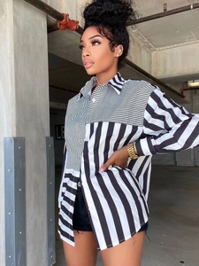 Detail of a women's striped long sleeve shirt with creative asymmetric pattern splicing