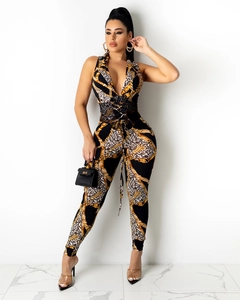 Macro detail of leopard print jumpsuit featuring chain patterns and lace-up waist