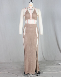 Detail of crochet knit two-piece set featuring cutout maxi skirt and halter bikini top