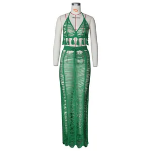 Detail of emerald green crochet beach set featuring halter top and fringed maxi skirt