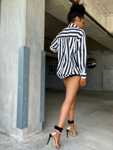 Side-rear view of loose black and white striped shirt with long sleeves and urban style
