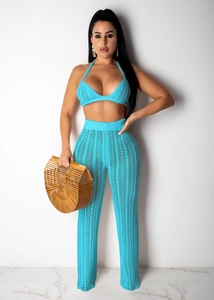 Detailed knit pattern of bright blue two-piece crochet halter top and wide-leg pants