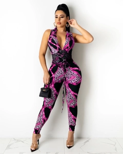 Detail of pink leopard jumpsuit with V-neck and black lace-up corset waist detail