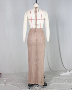 Detail of crochet knit beach set showing backless halter top and hollow out maxi skirt
