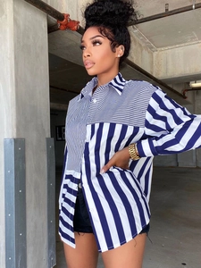 Detail of blue striped patchwork shirt featuring asymmetric wide and narrow stripes