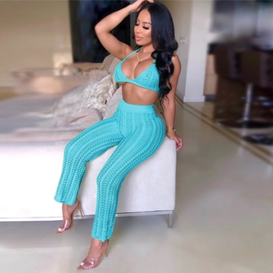 Detail of blue crochet two-piece set featuring hollow knit texture and halter top