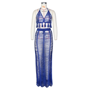 Detailed close-up of navy blue crochet knit beach set with tassels and hollow-out patterns
