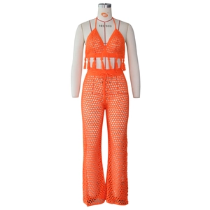 Detail of orange crochet two-piece set with hollow knit mesh and tassel hem decoration