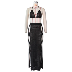 Detail of black crochet knit two-piece set featuring cutout maxi skirt and halter top