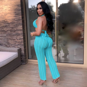 Detail of teal crochet knit two-piece set featuring hollow-out patterns and backless design