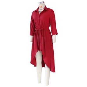 Detail of burgundy shirt dress with button-down collar and irregular high-low hemline