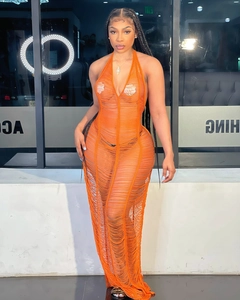 Detailed knit texture of a vibrant orange halter sheer maxi dress on a studio model