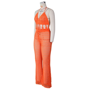 Detail of bright orange crochet hollow-out knit set with fringe hem and drawstring waist