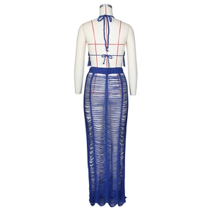 Rear view of navy blue hollow crochet knit two-piece set featuring halter top and maxi skirt