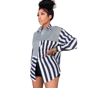 Detail of loose-fit shirt dress with unique black and white asymmetric striped patchwork