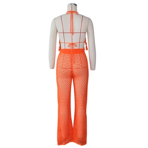 Back view of orange crochet two-piece set featuring halter top and sheer mesh knit pants