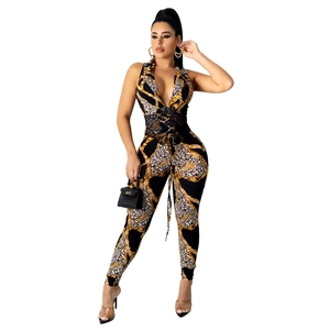 Detailed close-up of leopard and gold chain print jumpsuit with waist tie detail