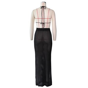 Detail of black hollow out mesh knit maxi skirt set with backless halter neck design
