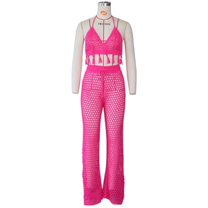 Detail of rose red crochet knit set with halter fringe top and mesh hollow pants