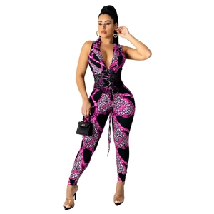 Detail of waist tie-up and cutout on pink leopard and chain print women's jumpsuit