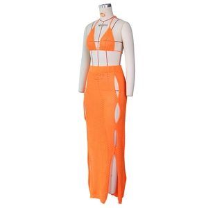 Detail of orange crochet two-piece beach set showing hollow out knit texture and pattern