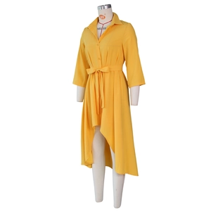 Detail view of yellow high-low shirt dress with adjustable waist belt and classic collar