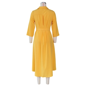Rear view of long bright yellow shirt dress with waist belt and pleated details