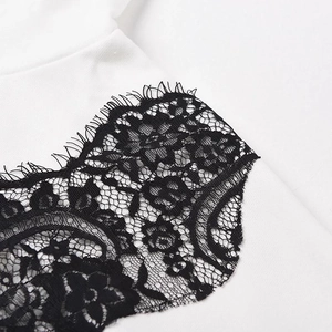 Gros plan sur le tissu blanc du sweat avec bordure en dentelle florale noire délicate