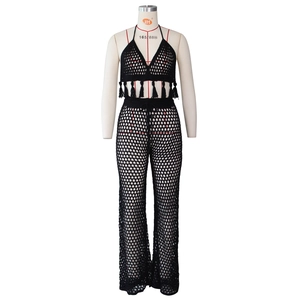 Detail of black crochet two-piece set featuring hollow knit texture and fringe accents