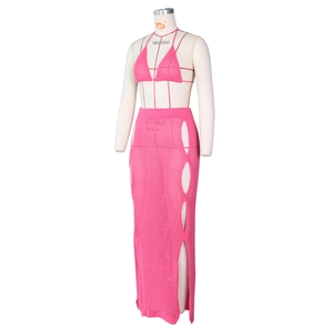Detail of pink crochet knit set featuring side oval cut-outs on a high-waisted maxi skirt