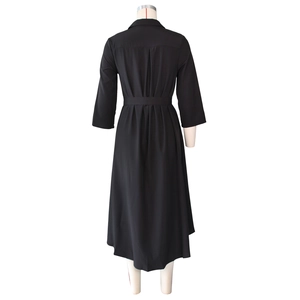 Detailed back view of a black long-sleeve shirt dress with waist tie and pleated details