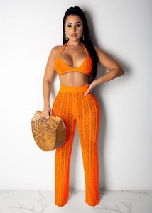 Detail view of the intricate crochet mesh pattern on orange two-piece summer set