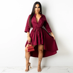Detail of wine red asymmetrical shirt dress with V-neckline and waist tie closure