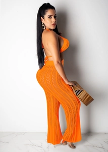 Close-up of vibrant orange crochet two-piece set featuring hollow mesh knit texture