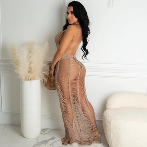 Detailed knit texture and tassel fringe of a beige crochet beach cover-up maxi dress