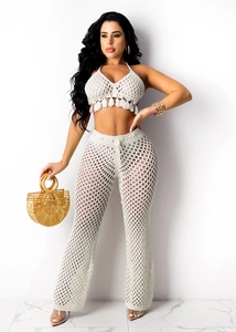Detailed close-up of beige crochet knit set featuring hollow mesh texture and tassels