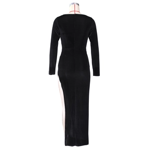 Detail view of the black velvet dress showing its slim fit and high side slit design