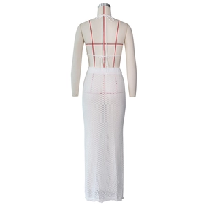 Rear view of white crochet two-piece skirt set with halter neck tie and mesh texture