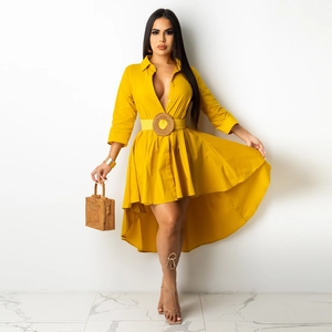 Detail of yellow midi shirt dress featuring waist belt with a round straw buckle