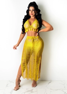 Detail of bohemian knit crochet beach set with hollow out design and fringe trim in yellow
