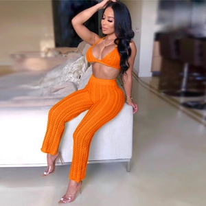 Detail of orange crochet two-piece set featuring hollow-out knit texture and bikini top